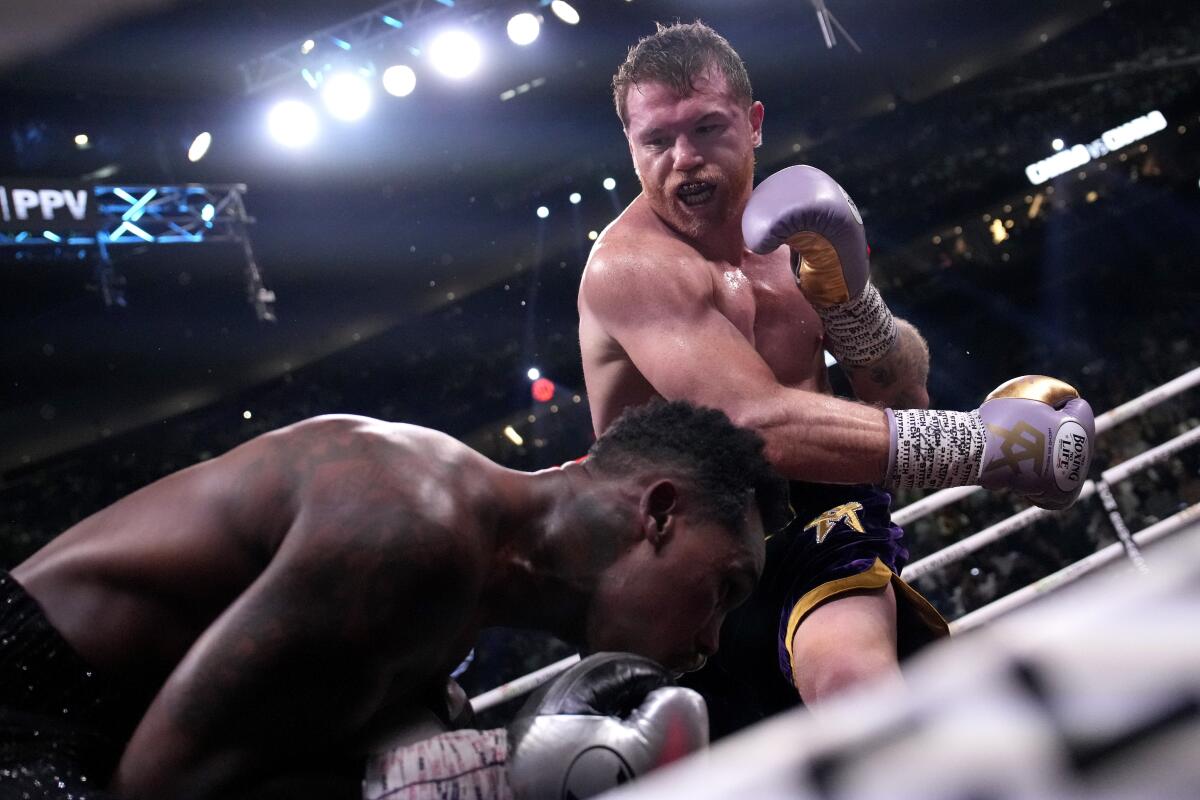 Canelo Alvarez, of Mexico, right, fights J 