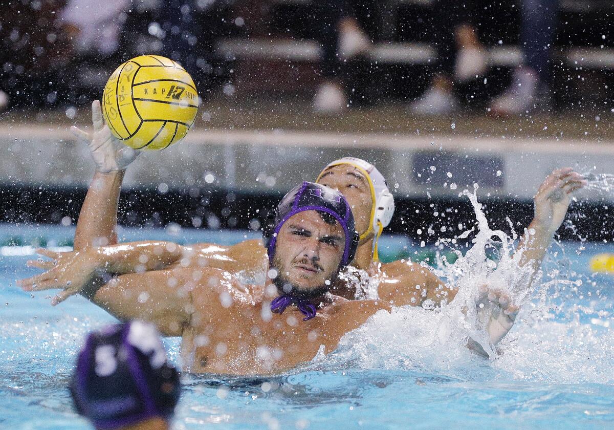 Hoover's Hayk Nazaryan winds up to shoot as his arm is knocked by Arcadia's Andrew Tran to free the ball in a Pacific League boys' water polo final at Arcadia High School on Thursday, October 31, 2019. Hoover won the Pacific League title beating Arcadia 10-6.