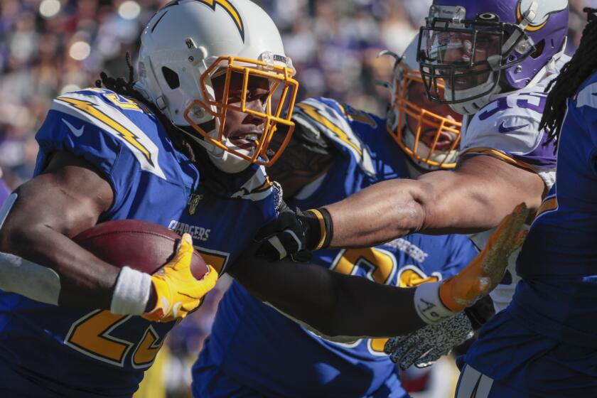 CARSON, CA, SUNDAY, DECEMBER 15, 2019 - Los Angeles Chargers running back Melvin Gordon (25) rushes past Minnesota Vikings outside linebacker Anthony Barr (55) during a first half drive at Dignity Health Sports Park. (Robert Gauthier/Los Angeles Times)