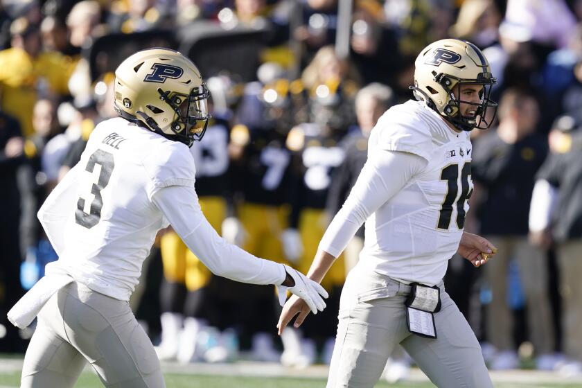 Purdue quarterback Aidan O'Connell (16) celebrates with wide receiver David Bell (3) on Oct. 16, 2021, in Iowa City, Iowa.