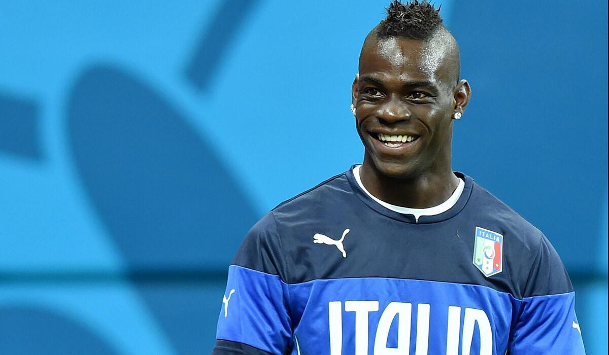 Italy forward Mario Balotelli is all smiles during a training session on Friday.