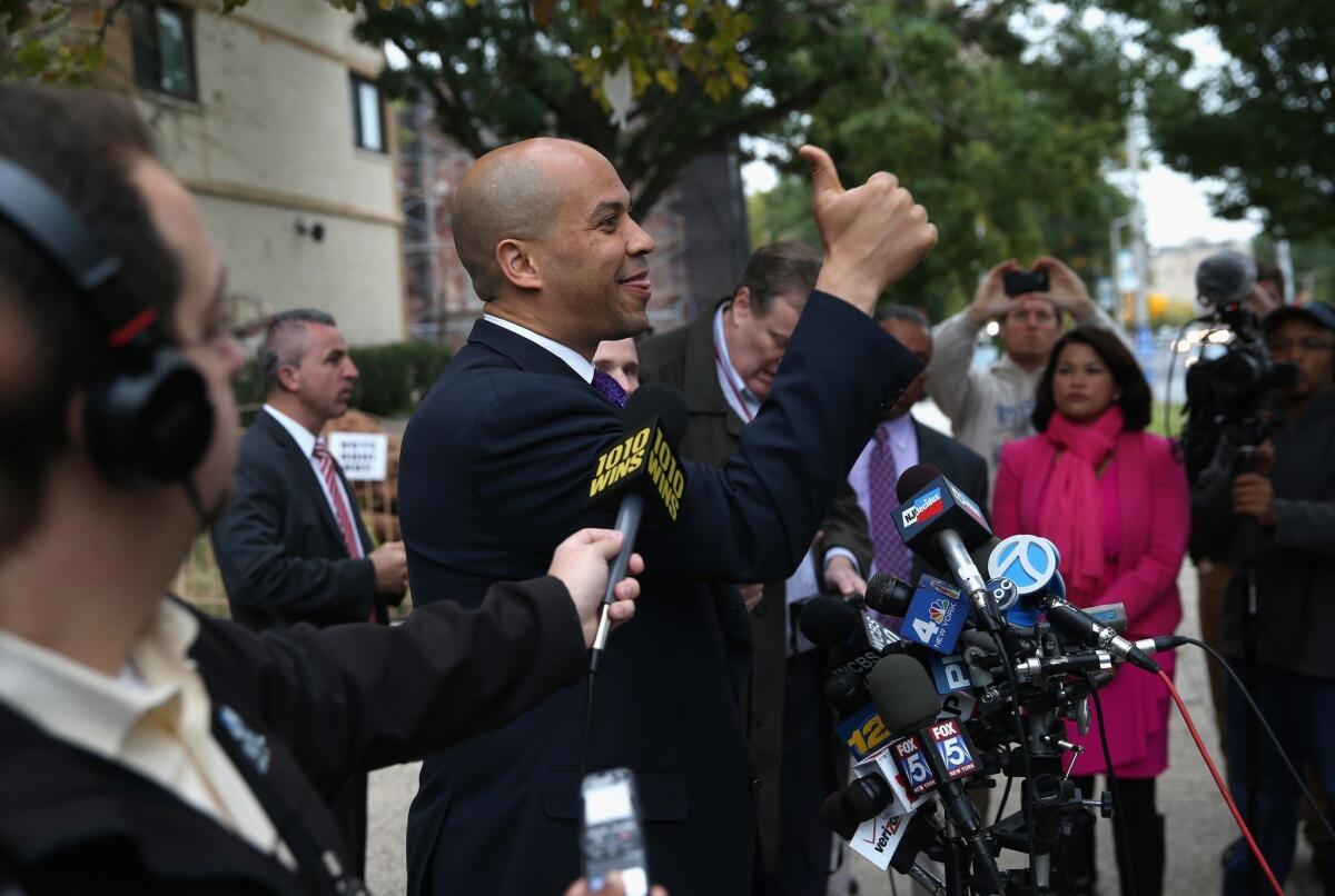 Newark Mayor Cory Booker greets a supporter after casting his vote in a special U.S. Senate election Wednesday. Booker, a Democrat, was leading in pre-election surveys over Republican Steve Lonegan.