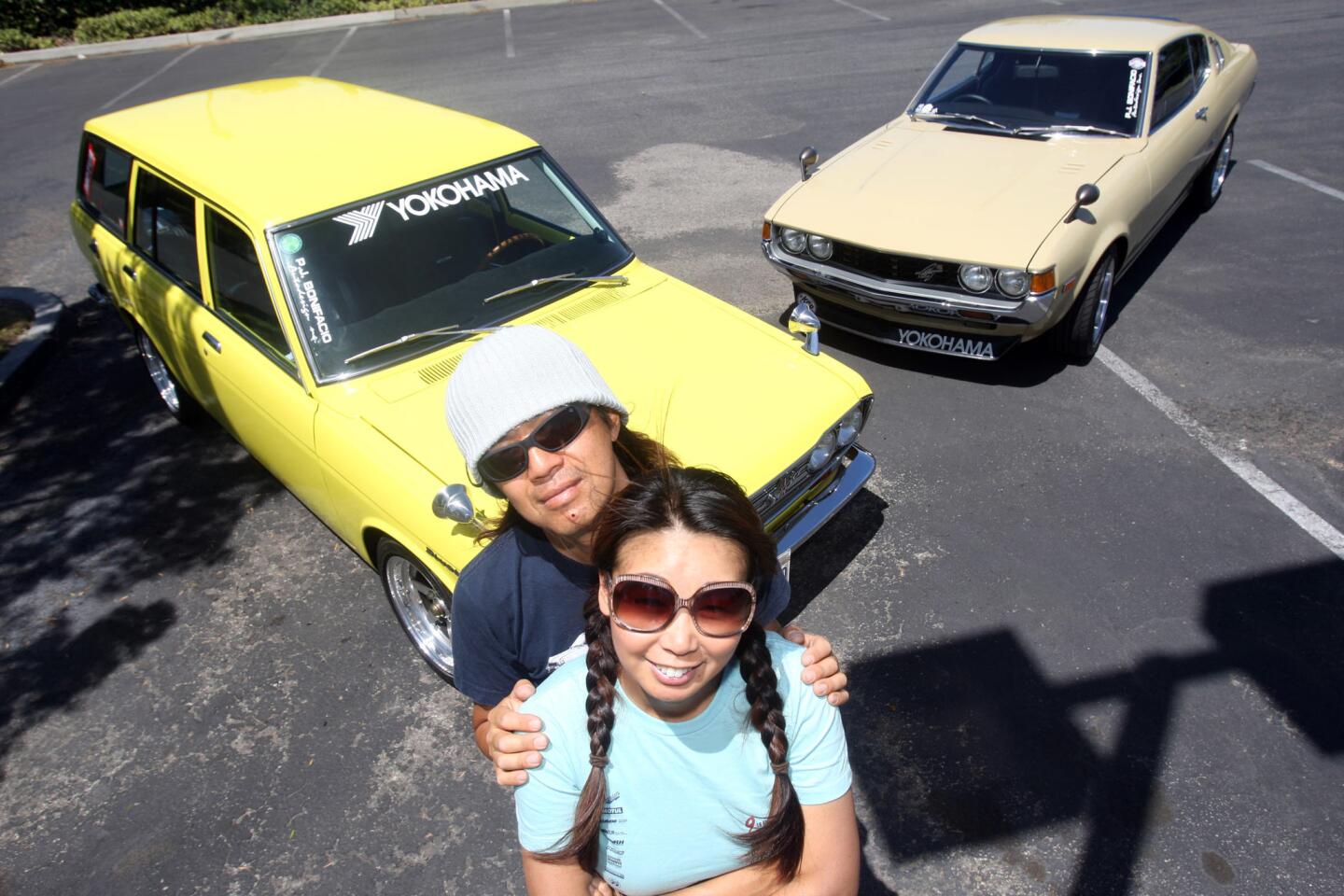 Terry, right, and Koji Yamaguchi with two of their classic cars on May 14 in La Mirada. They have a 1972 Datsun 510 wagon, left, and a 1977 Toyota Celica liftback. They are organizers of the 10th Annual Japanese Classic Car Show.