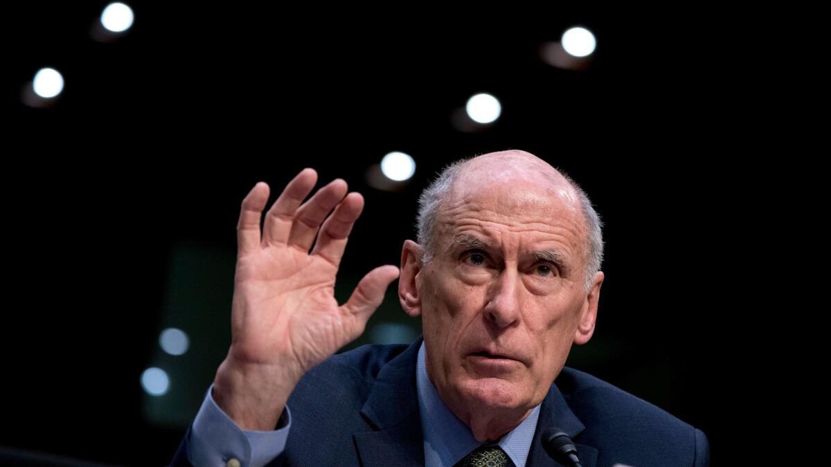 Director of National Intelligence Dan Coats speaks at a Senate Select Committee on Intelligence hearing on Tuesday. He warned that Russians will continue to try to influence U.S. campaigns.
