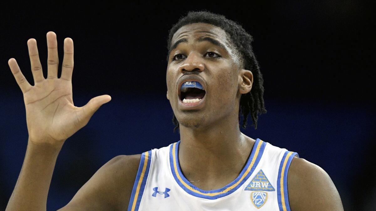 UCLA guard Chris Smith motions to teammates in a game against Presbyterian.