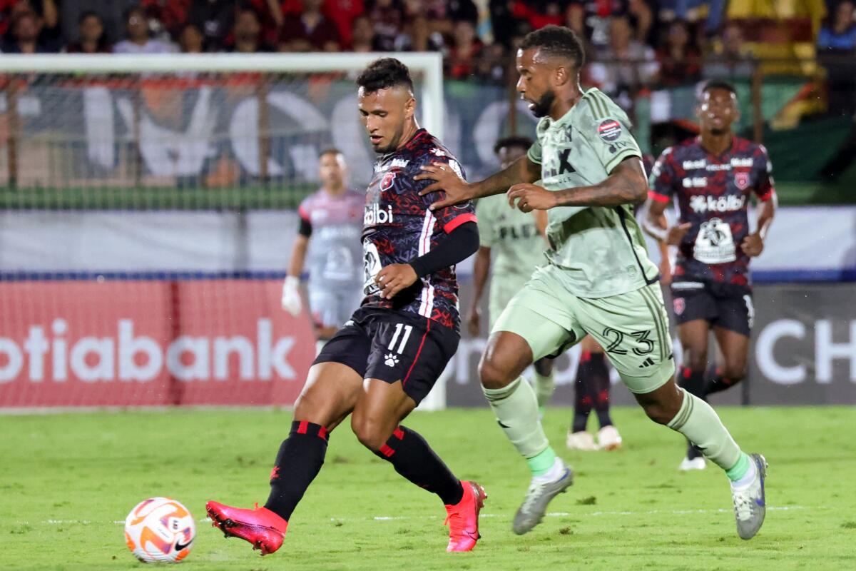 Alajuelense Sports League's Alexander Lopez goes for the ball against LAFC's Kellyn Acosta.