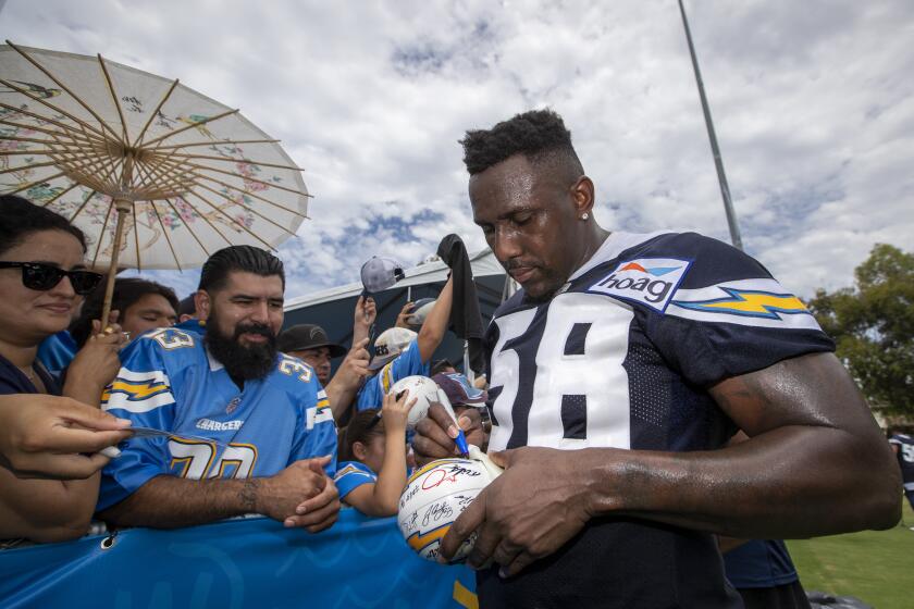 COSTA MESA, CALIF. -- THURSDAY, JULY 25, 2019: Chargers linebacker Thomas Davis Sr. signs autographs for fans as the Chargers conduct their first training camp practice of 2019 at the Jack Hammett Sports Complex in Costa Mesa, Calif., on July 25, 2019. (Allen J. Schaben / Los Angeles Times)