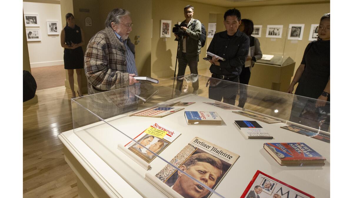 Lawrence Schiller, left, exhibition curator and filmmaker, guides members of the media through "American Visionary: John F. Kennedy's Life and Times" exhibit at Bowers Museum in Santa Ana on March 9.
