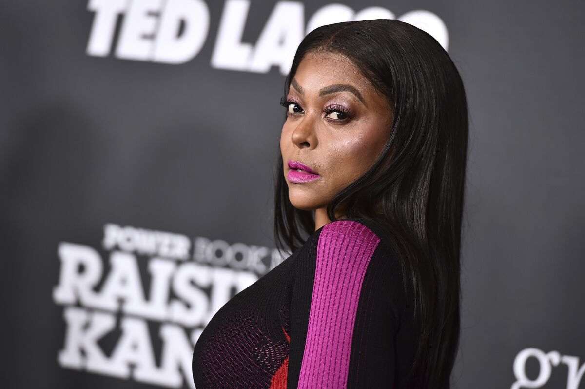 Taraji P. Henson posing in a black and pink outfit