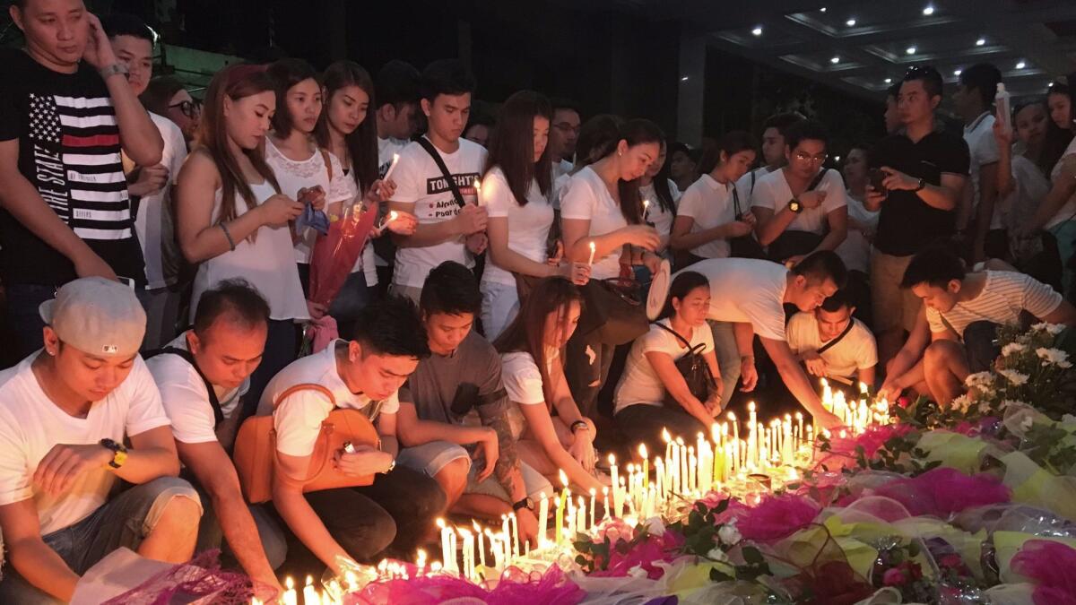 Mourners in Manila pay tribute to victims of the attack at Resorts World Manila.