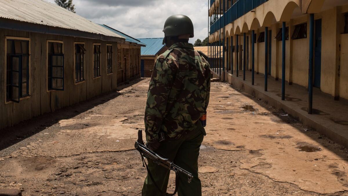 Voter turnout in Thursday's controversial repeat Kenyan presidential election was low. A Kenyan police officer stands inside an empty school, serving as a polling station.