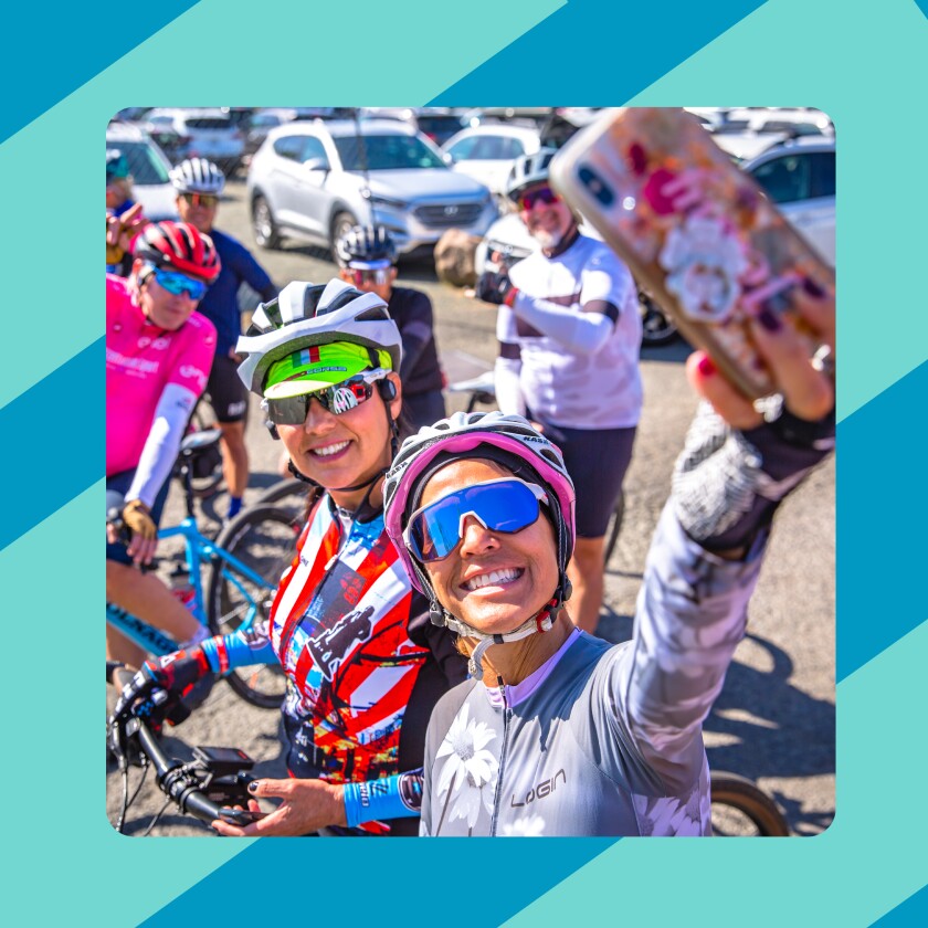 Two women on bicycles taking a selfie