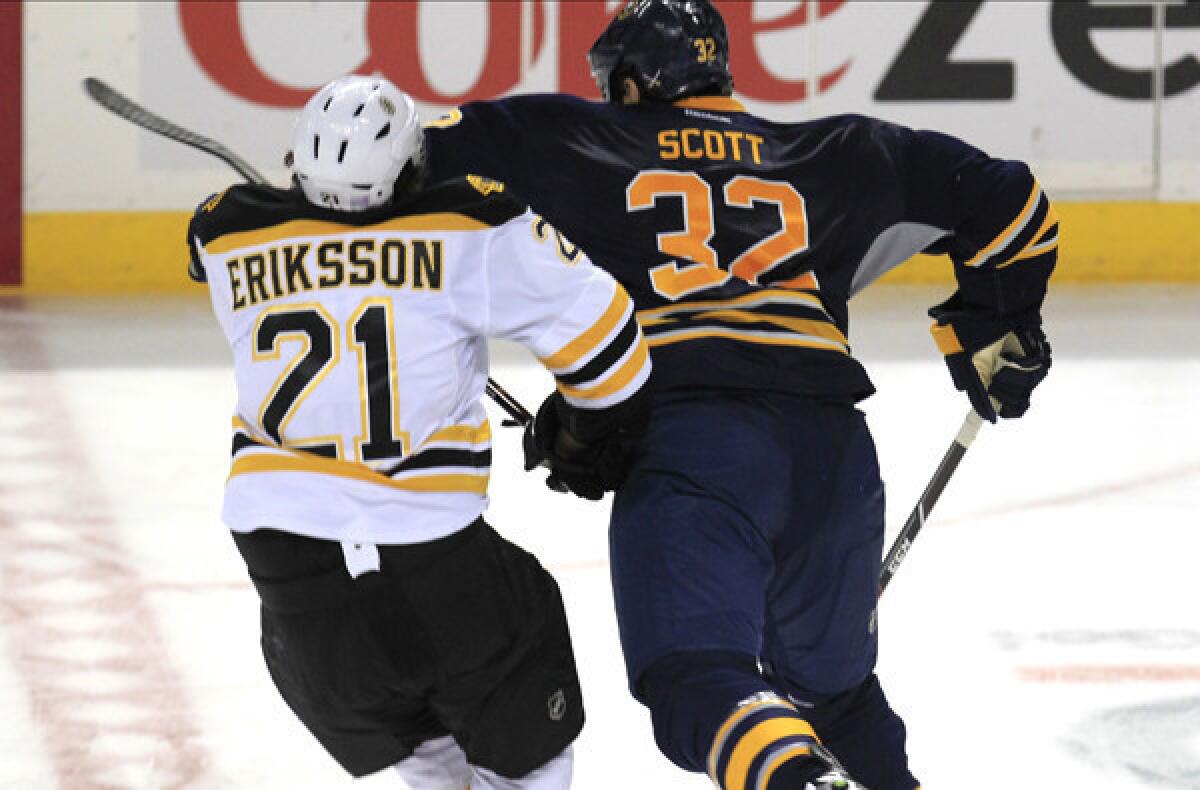 Buffalo left wing John Scott delivers a blow to the head of Bruins left wing Loui Eriksson during third period of their game last week.