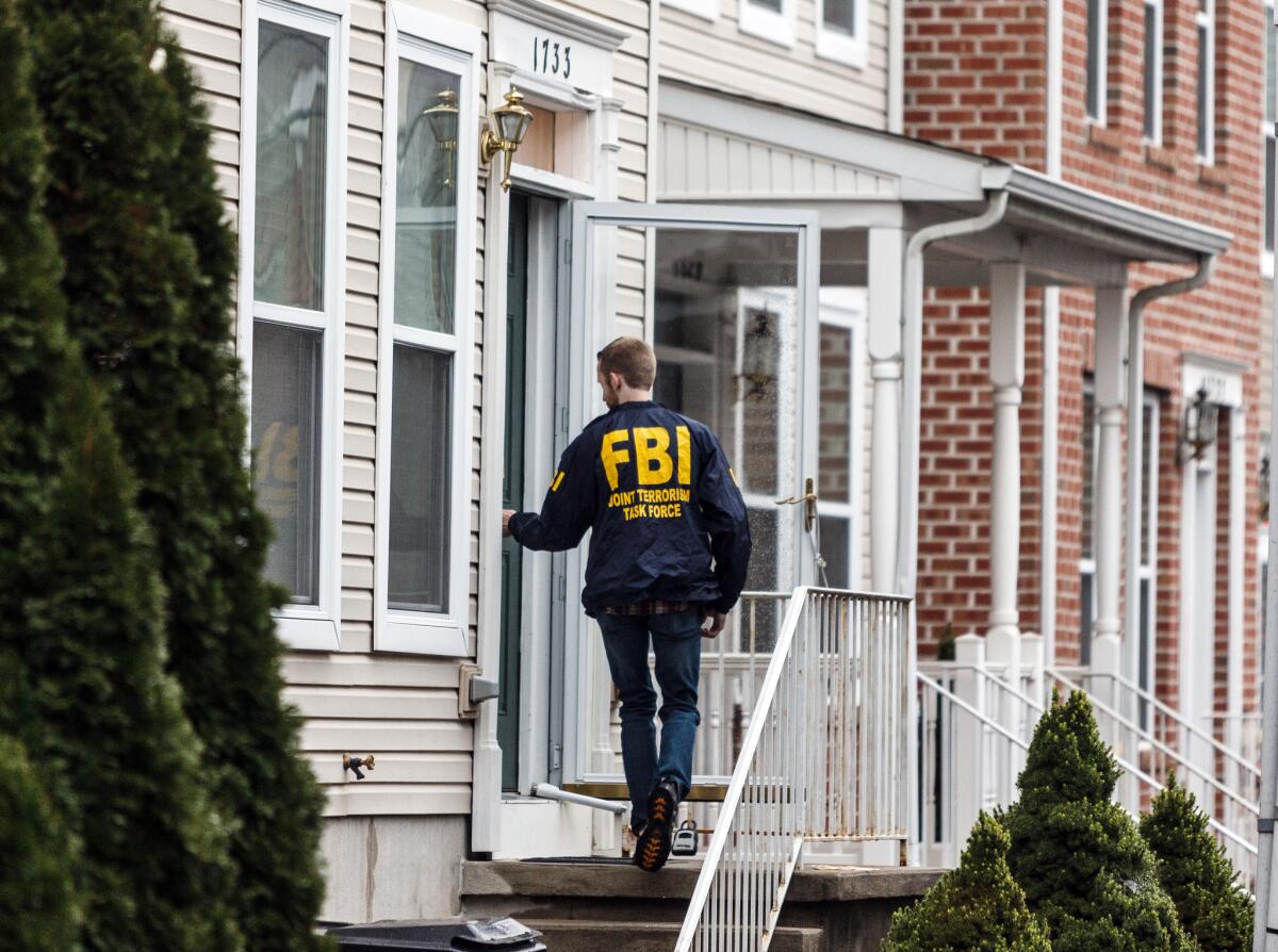It's been a busy year for the FBI as it's launched terrorism-related investigations in every state. Here, an FBI Joint Terrorism Task Force member enters a home in Harrisburg, Pa., on Dec. 17 in connection with a terror investigation.