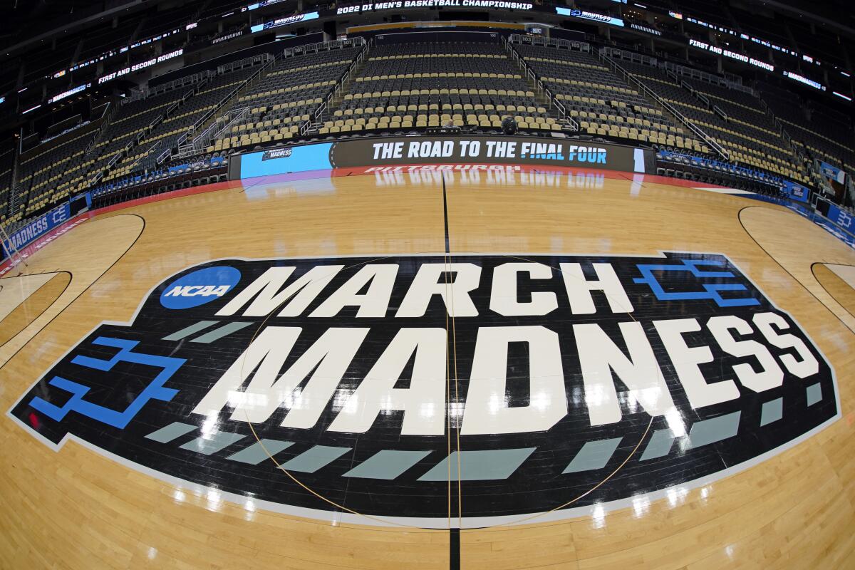 The basketball court at PPG Paints Arena in Pittsburgh is prepared with a March Madness logo.