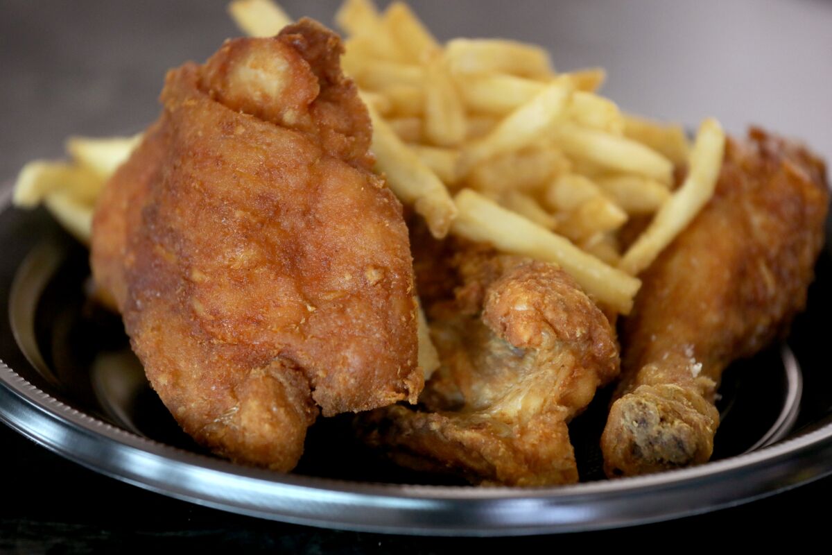 A plate of fried chicken and french fries.