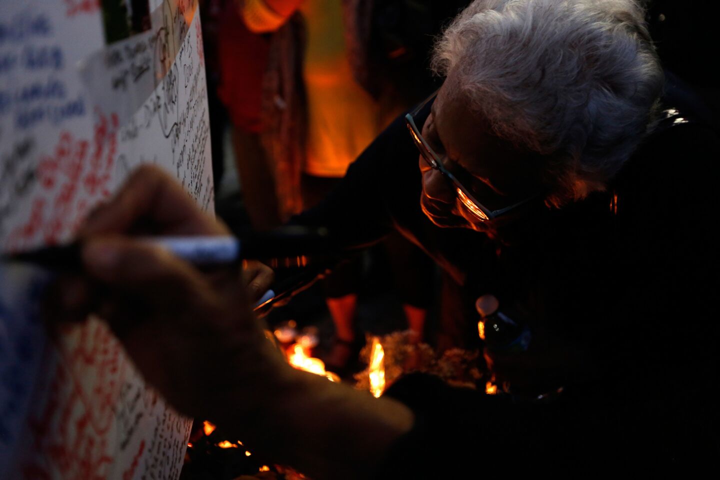 Felipa Martinez leaves her condolences while attending a Los Angeles vigil for the victims of the tour bus crash in Desert Hot Springs.