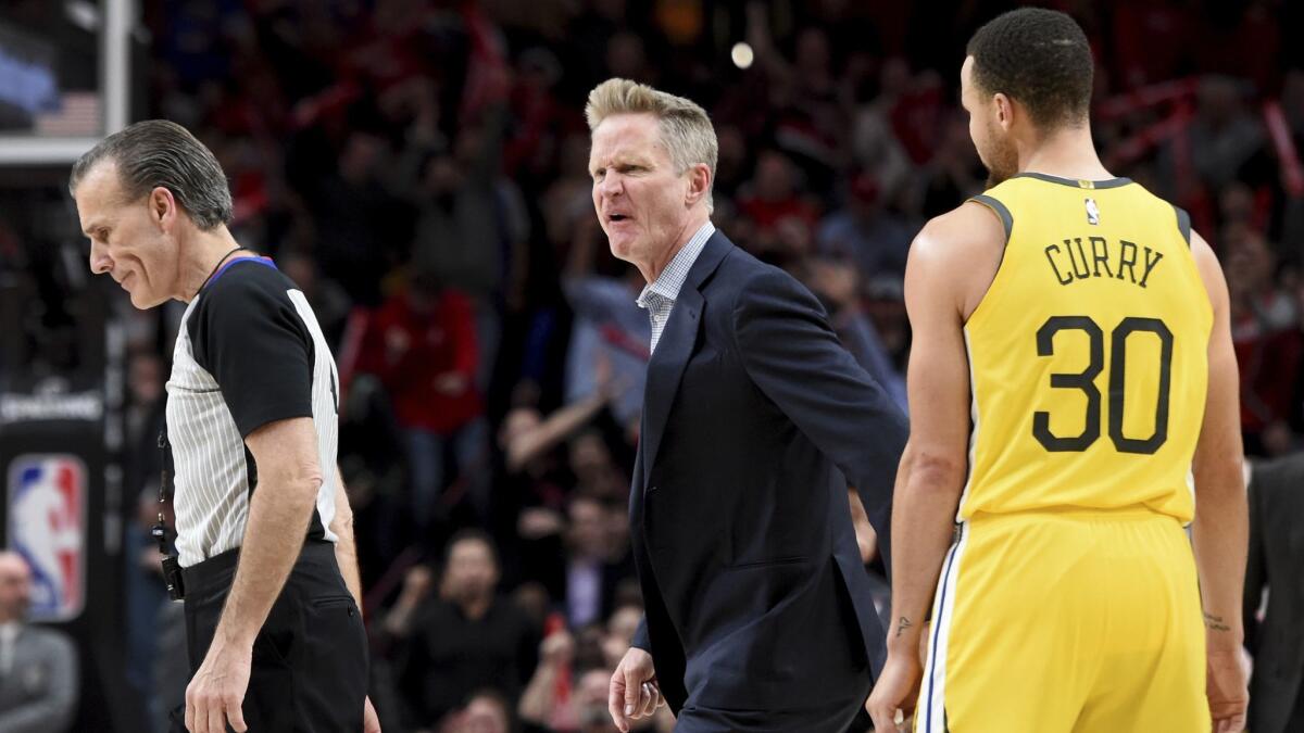 Golden State Warriors coach Steve Kerr, center, yells at referee Ken Mauer, left, after being called for a technical foul, while guard Stephen Curry, right, watches during the second half against the Portland Trail Blazers.