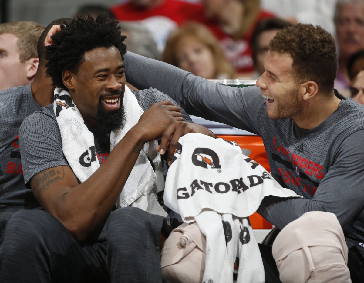 Clippers center DeAndre Jordan, left, jokes with forward Blake Griffin on the bench during the second half of a game against the Nuggets.