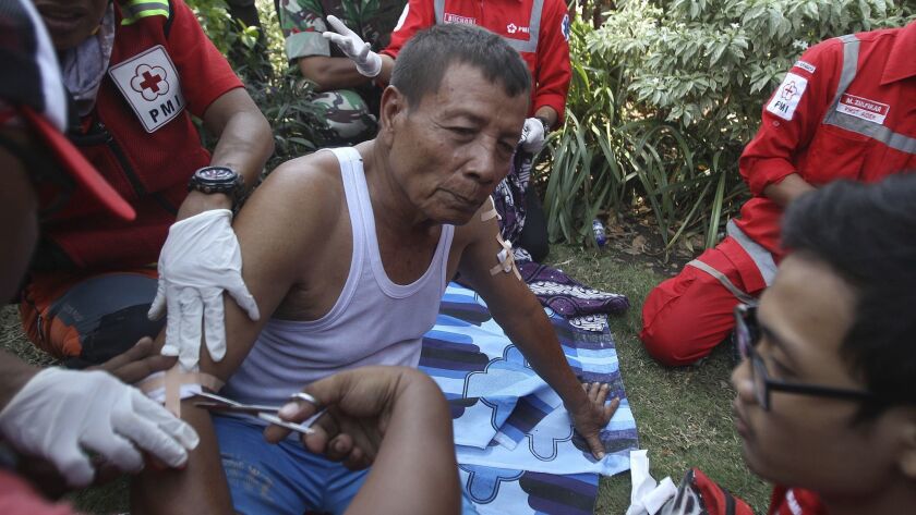 Paramedics treat an Indonesian man injured in a church explosion on May 13, 2018, in Surabaya, East Java.