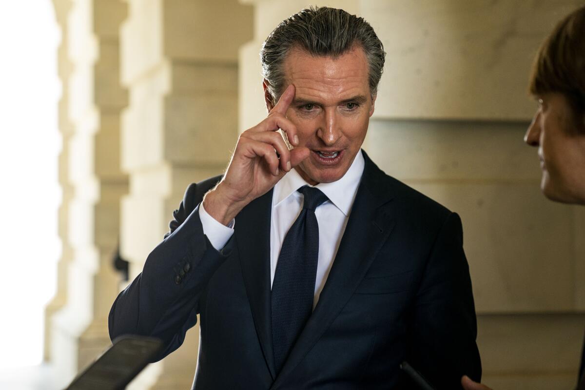 California Gov. Gavin Newsom speaks with reporters.