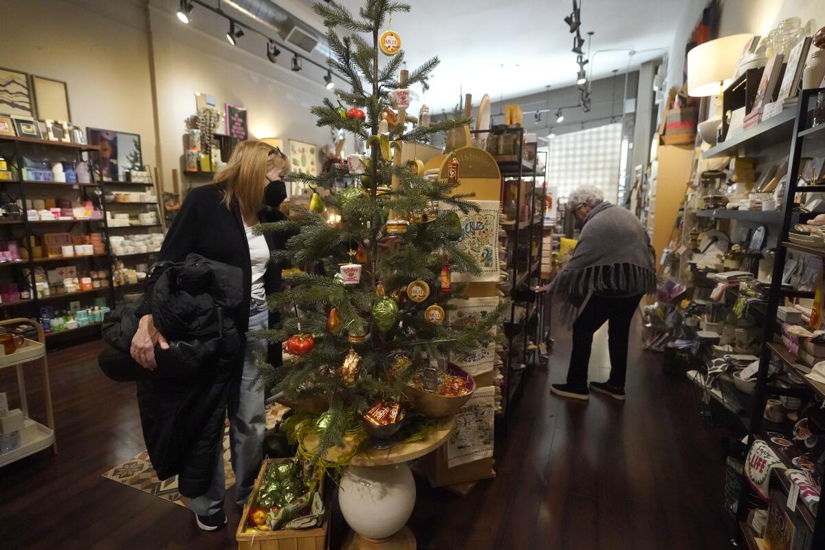 Customers shop at a store decorated for the holidays