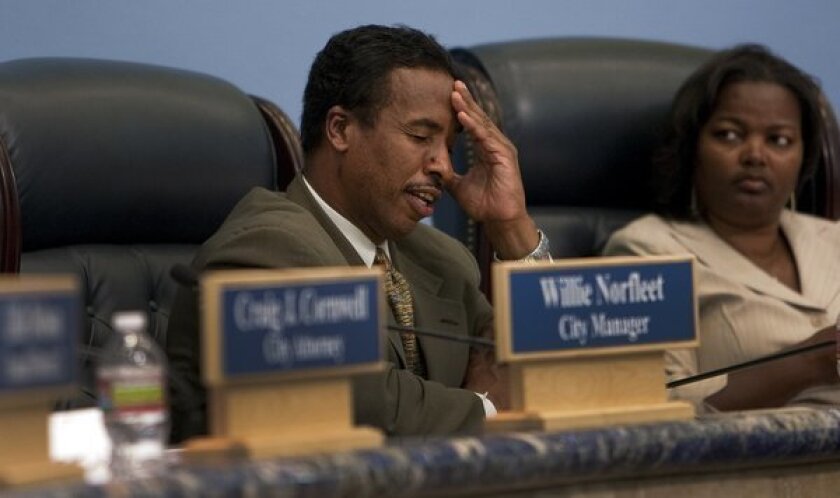 Compton Mayor Eric Perrodin tries to keep his composure at a 2011 City Council meeting. His seat and two council seats are up for grabs in the city's upcoming municipal election.