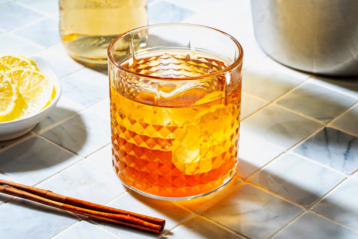 A spiced-cider Old Fashioned in a glass with ice.