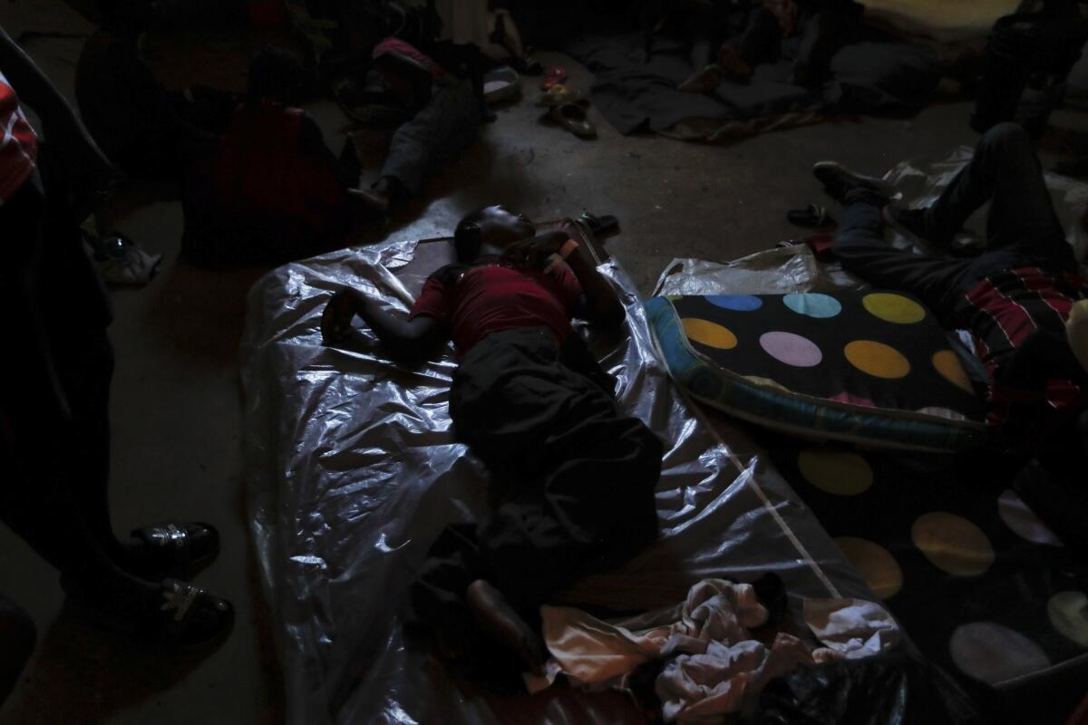 Man sleeping in a shelter for displaced Haitians
