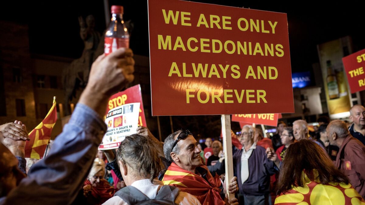 Supporters of the movement to boycott the referendum vote celebrate in the streets of Skopje, Macedonia, after election officials announced low voter turn out figures on Sunday.