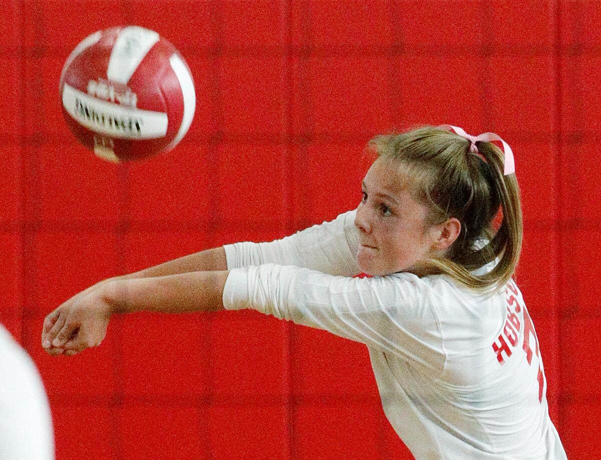 Burroughs' Carlotte Hobson hits a deep Crescenta Valley serve into play in a Pacific League girls' volleyball match at Burroughs High School on Tuesday, October 8, 2019.