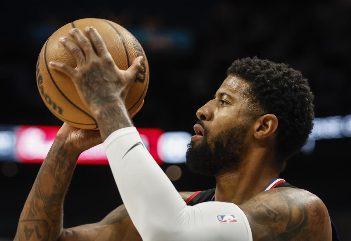 A closeup of Clippers forward Paul George aiming to take a shot.