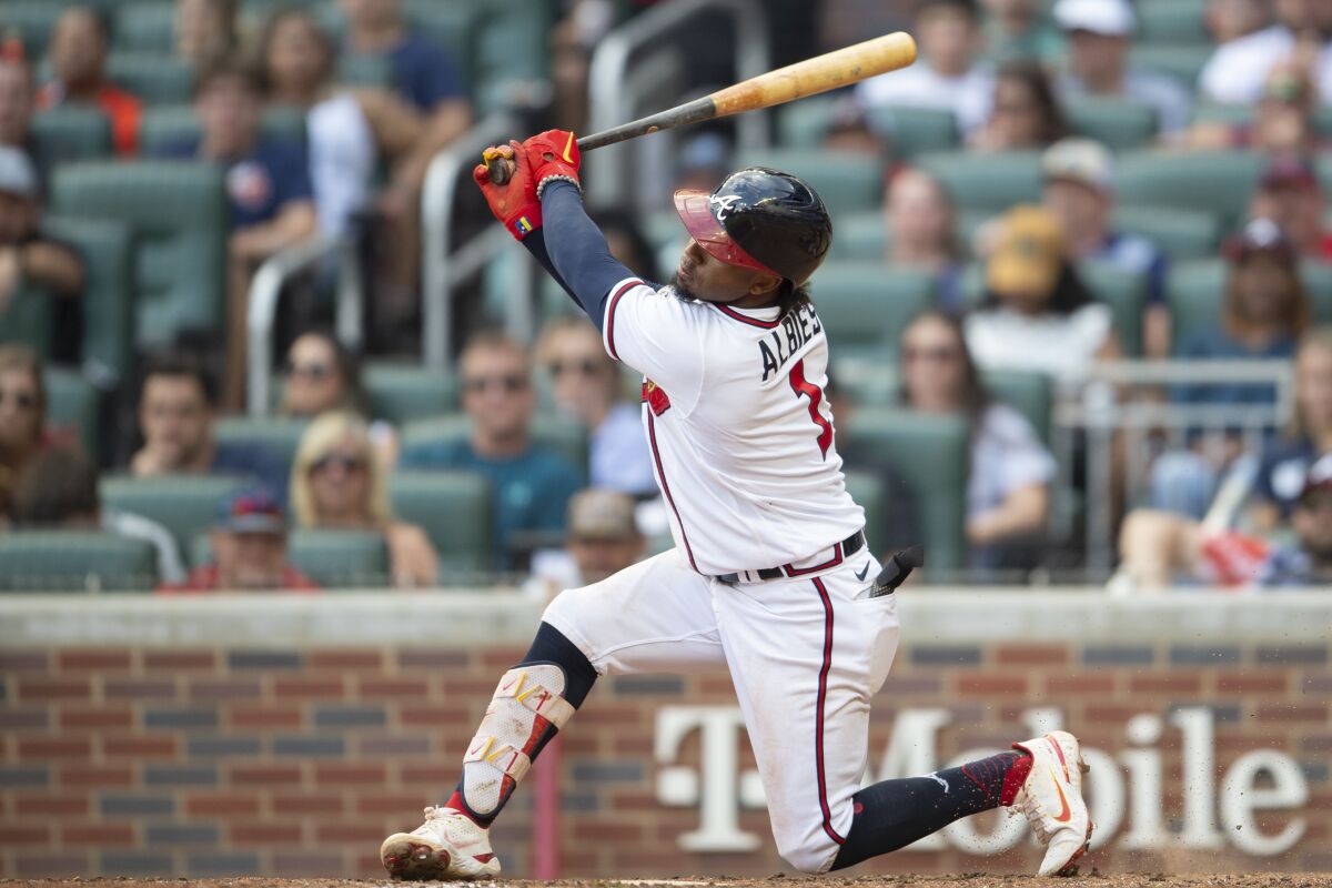 Atlanta Braves' Ozzie Albies (1) hit a grand slam to center right center field which also scored Dansby Swanson, Austin Riley and Matt Olson in the seventh inning of a baseball game against the Pittsburgh Pirates, Saturday, June 11, 2022, in Atlanta. (AP Photo/Hakim Wright Sr.)