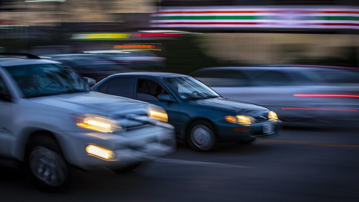 L.A. officials are considering raising speed limits on more than 100 miles of city streets in order to comply with a state law that has prevented police officers from ticketing speeders. Above, cars travel along Zelzah Avenue in the San Fernando Valley.