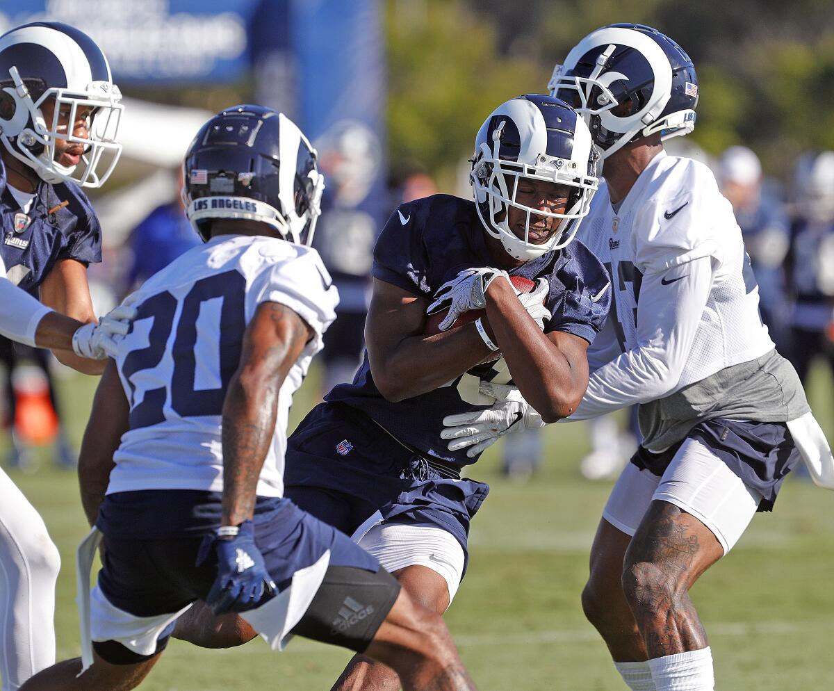Rams running back Justin Davis carries the ball at training camp on July 27, 2019.