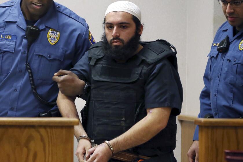 Ahmad Khan Rahimi, convicted of setting off bombs in New Jersey and New York, is led into court in Elizabeth, N.J. on Dec. 20, 2016.