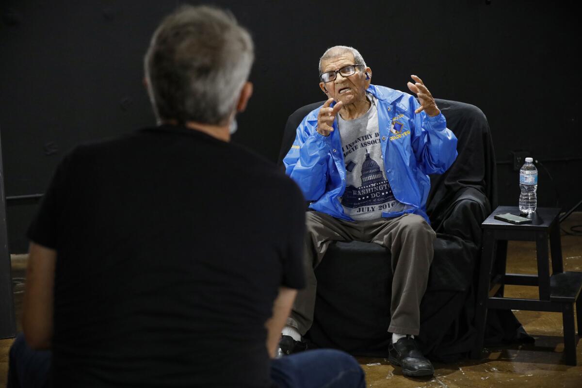 Photographer Mickey Strand, foreground, photographs Joe Albert Gonzalez.