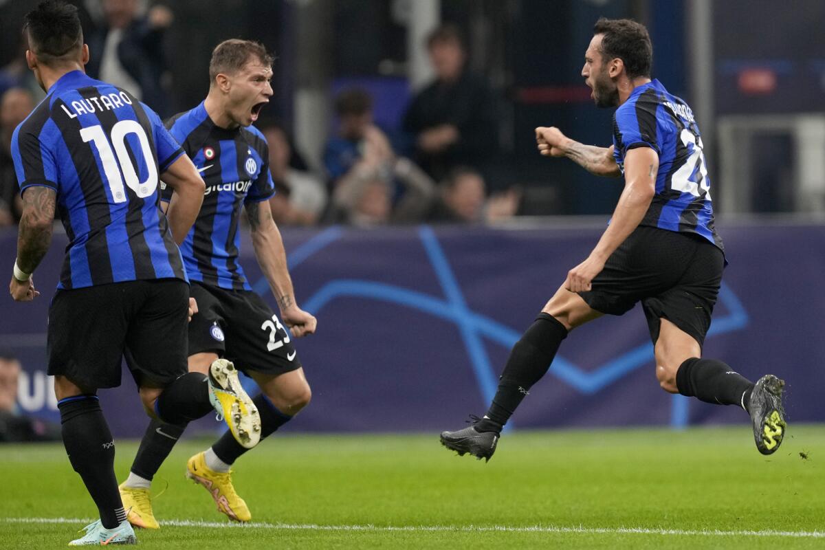 Inter Milan's Hakan Calhanoglu celebrates scoring the opening goal during the Champions League group C soccer match between Inter Milan and Barcelona at the San Siro stadium in Milan, Italy, Tuesday, Oct. 4, 2022. (AP Photo/Antonio Calanni)