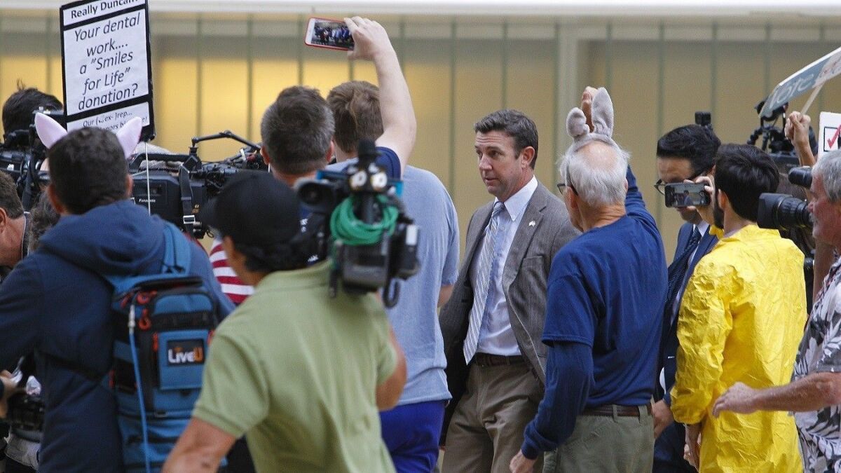 Congressman Duncan Hunter is met with protesters outside a recent San Diego federal court hearing.