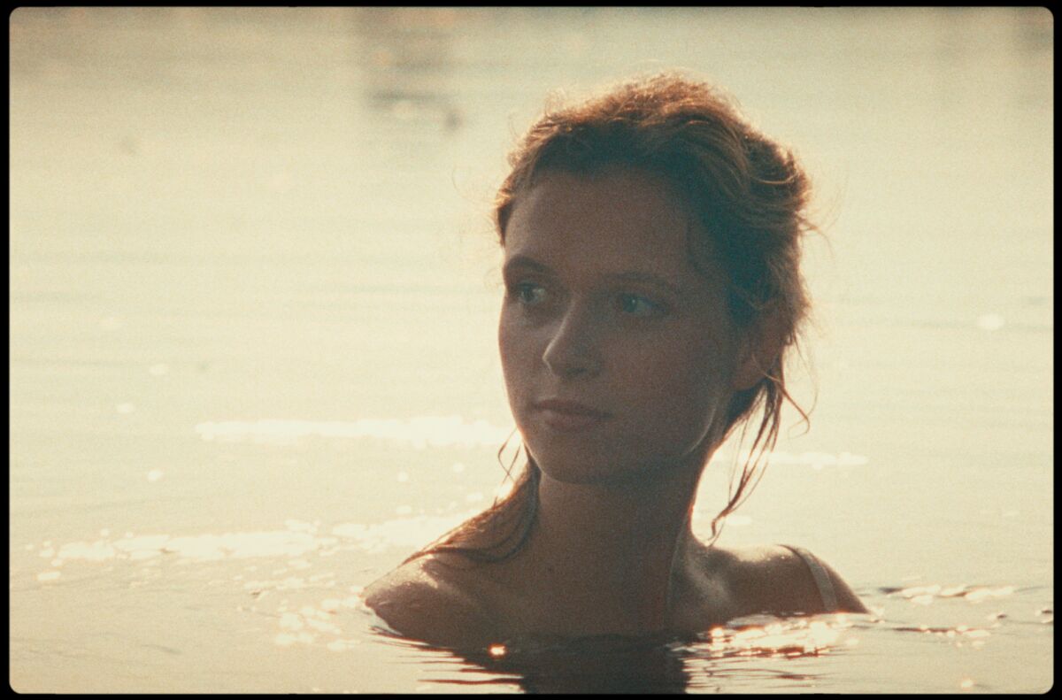 A young woman in water up to her shoulders