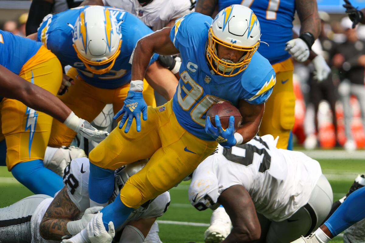 Chargers running back Austin Ekeler is tackled as he carries the ball during a win over the Las Vegas Raiders.