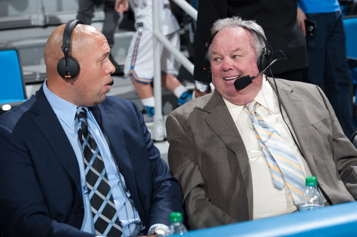UCLA play-by-play broadcaster Chris Roberts, right, chats with analyst Tracy Murray.