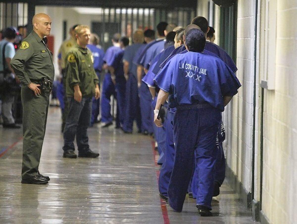 Inmates are watched by members of the Los Angeles County Sheriff's Department at the Men's Central Jail in Los Angeles.
