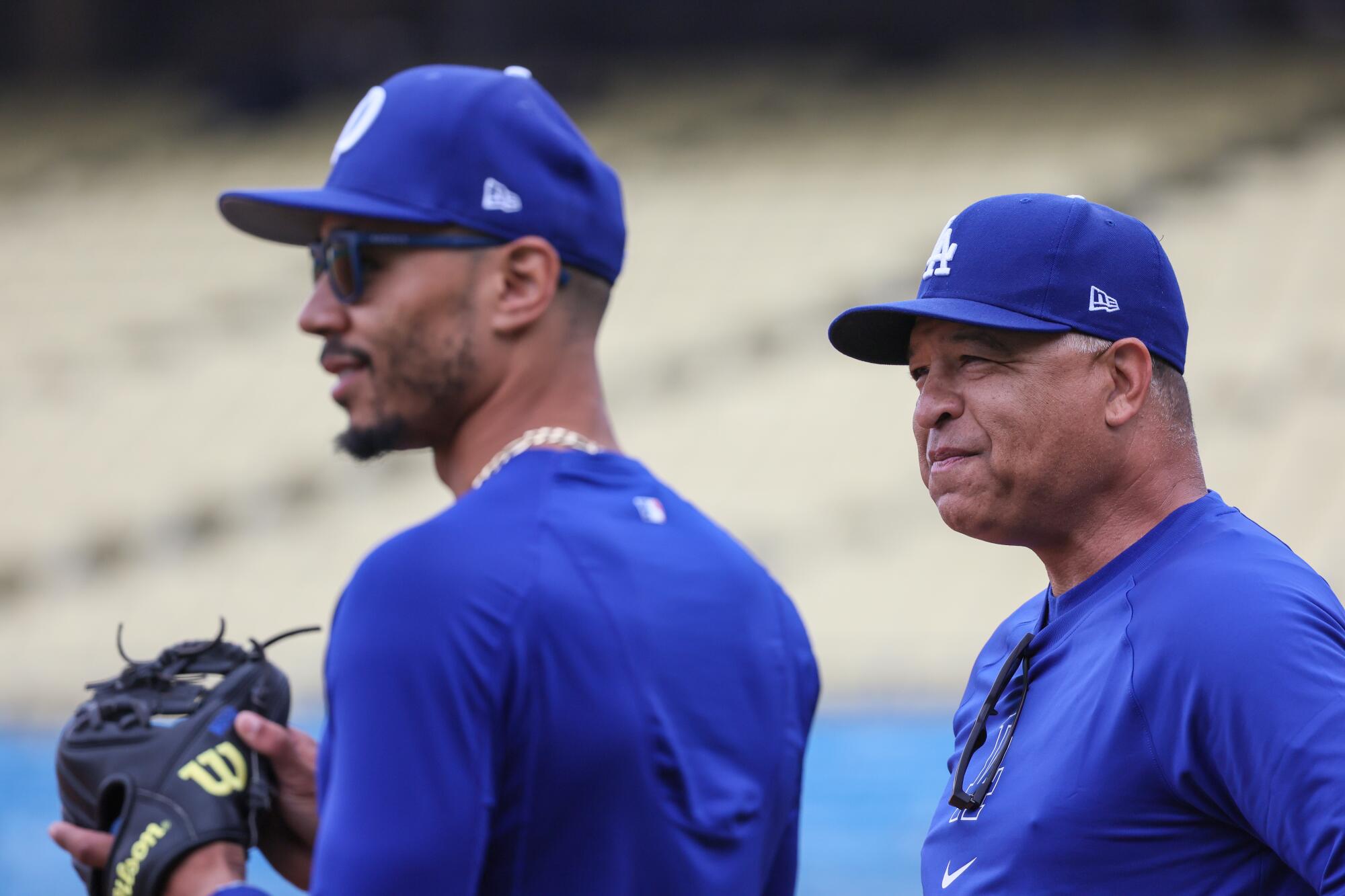 Dodgers manager Dave Roberts talks with Mookie Betts before a recent game against the Rockies at Dodger Stadium.