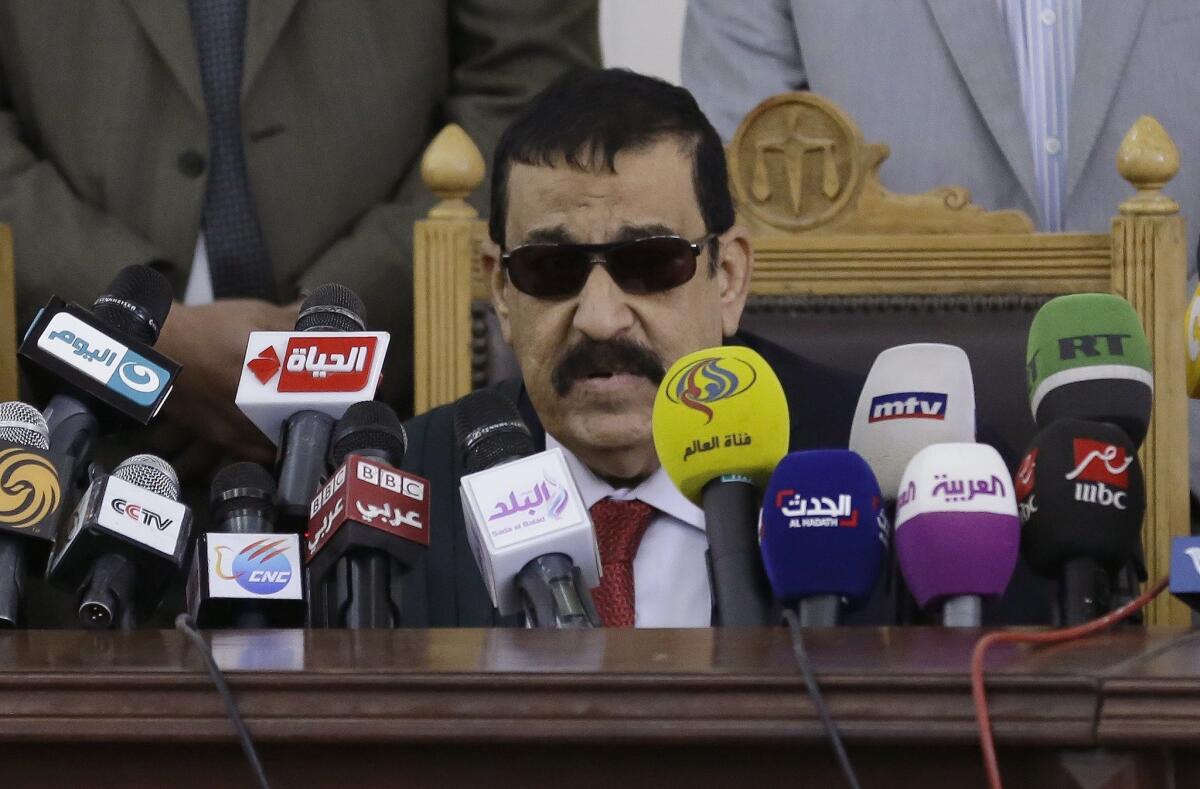 Egyptian Judge Nagy Shehata reads the verdicts in a case rooted in violence that swept the country after the military-led ouster of Islamist President Mohamed Morsi in 2013.