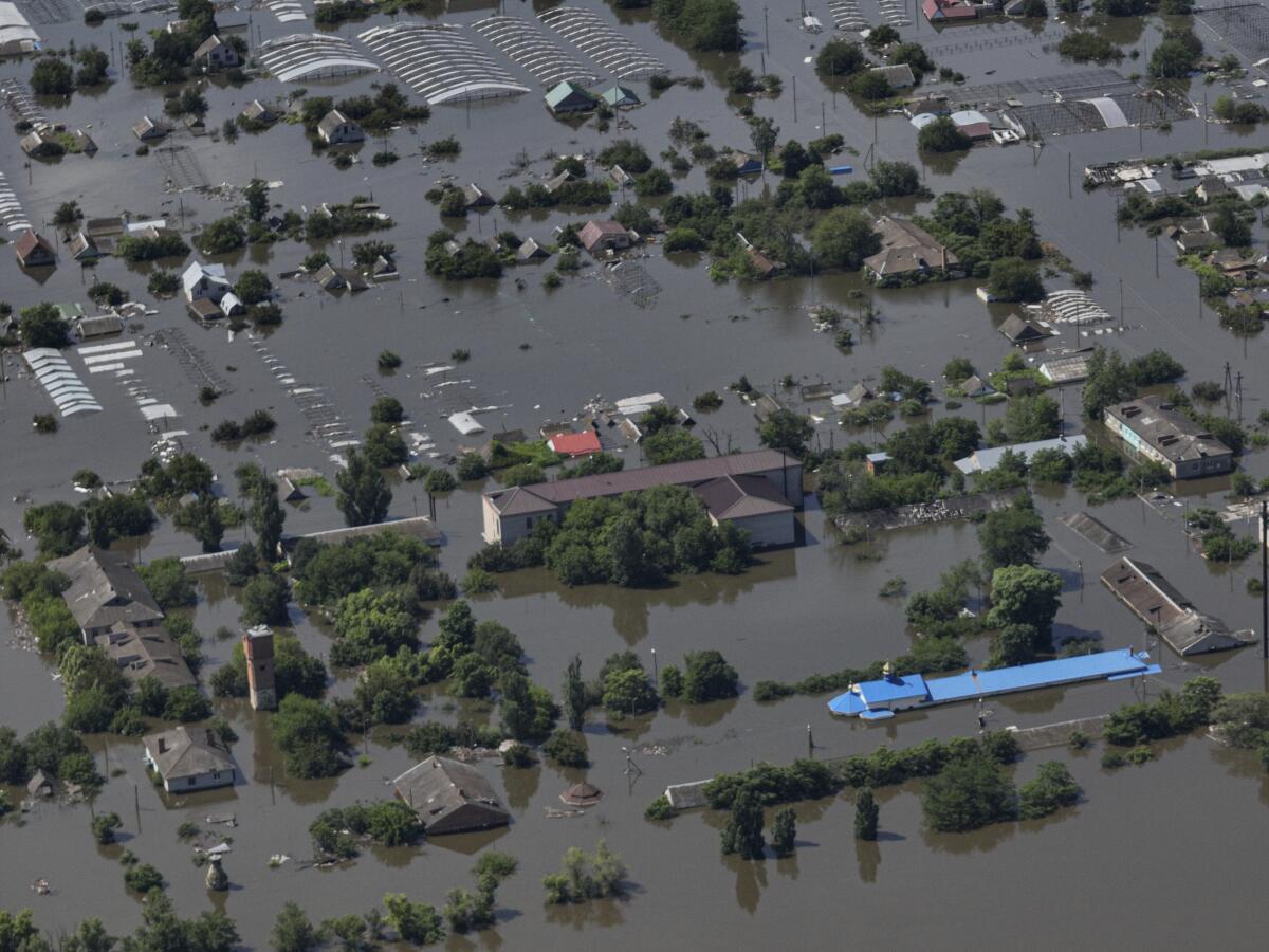 An aerial view of houses submerged in floodwaters 