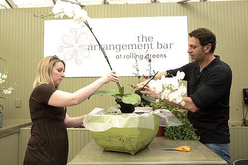 Bartenders, sort of ROLLING GREENS is calling all creative types with an eye for botanical design. The company recently opened an "arrangement bar" where shoppers can create custom pots and planters, perhaps for the patio table or outdoor living room. Nursery co-owner Greg Salmeri (below, with manager Angela Tapp) says the idea stems from one client's special request. "They asked, 'Can you put this plant with this plant with this plant?' And we thought we could do more of this," Salmeri says. Now customers follow a simple drill. Step 1: Select one of Rolling Greens' thousands of containers, which include inexpensive metal boxes, fancy European imports and stunners made of faux seashells or gnarled wood. Step 2: Choose your plants — ferns, orchids or perhaps less conventional picks ("begonias over gerbera daisies, hydrangeas instead of roses," Salmeri suggests). Step 3: Choose the top dressing: mosses, pebbles, even recycled glass in more than a dozen hues. Professional designers put together your selections at a counter with barstools, where you can watch while sipping iced tea or coffee. Unlike cut flowers, these arrangements can last a month or more. The best part: When friends ooh and ahh over the design, you can take credit. 9528 Jefferson Blvd., Culver City; (310) 559-8656; http://www.rollinggreensnursery.com. --Leslee Komaiko