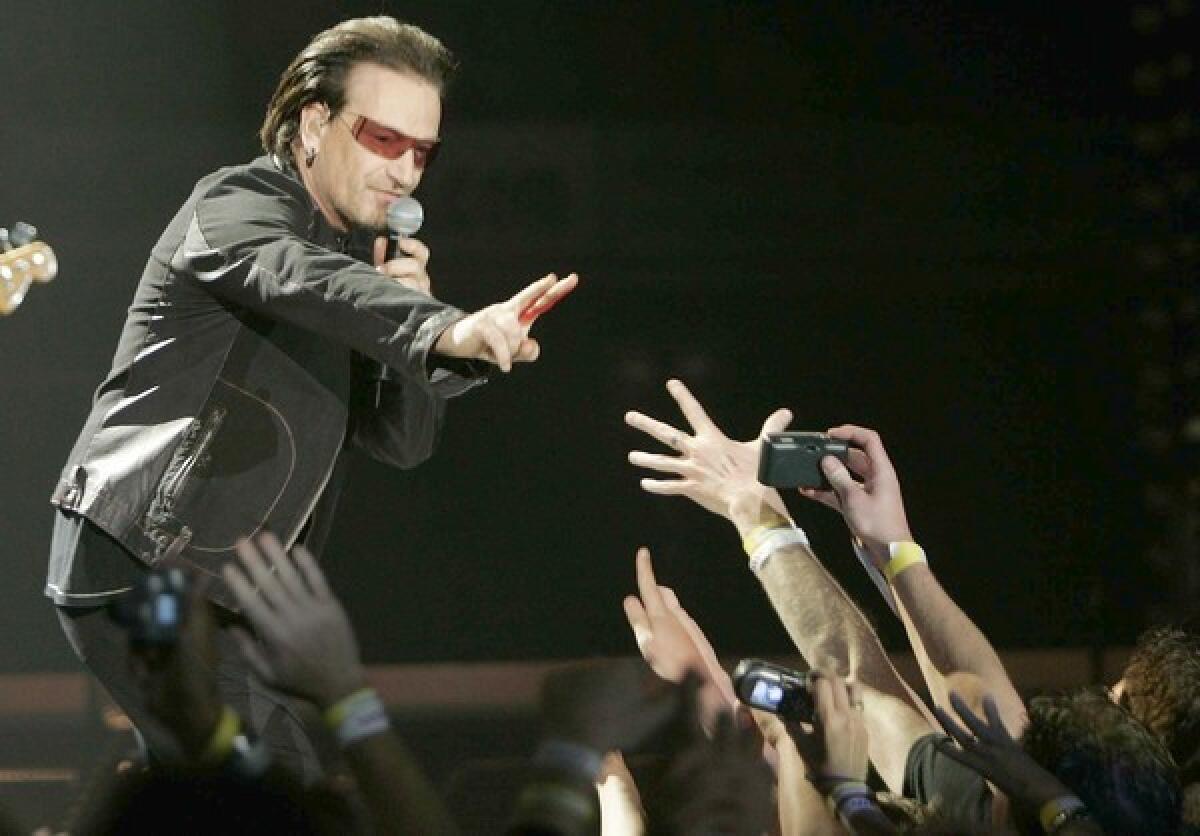 A SIGN: Bono spreads a message at a concert in San Diego in 2005. With Robert Hilburn, he considers rock's future.