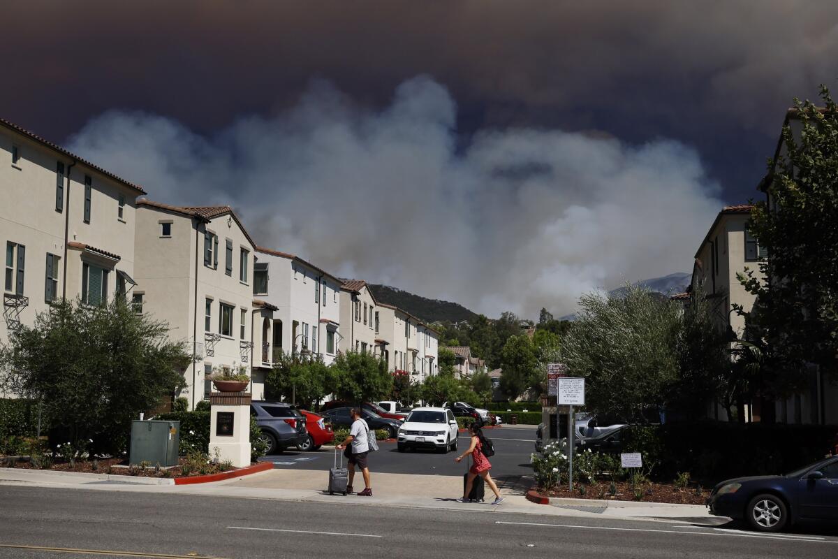 Trabuco Canyon residents evacuate as the Airport fire rages. The fire has charred more than 9,000 acres.