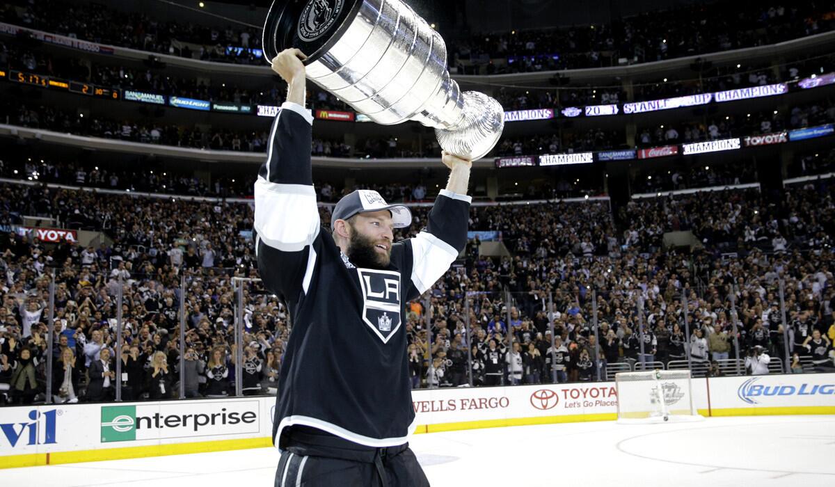 Kings defenseman Robyn Regehr, who did not play in the Stanley Cup Final because of injury, was the second player to skate with the Cup when captain Dustin Brown handed it off.